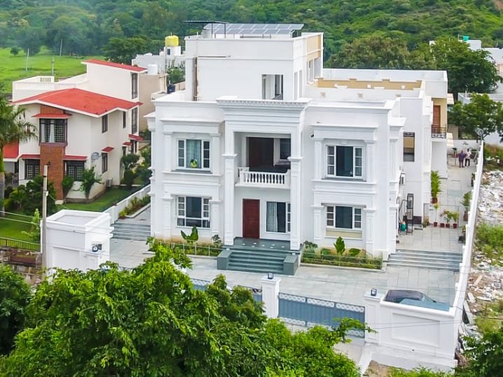 Aerial view of Chez Lavania — hotels in Udaipur near Lake Pichola with Aravali hills and Monsoon Palace